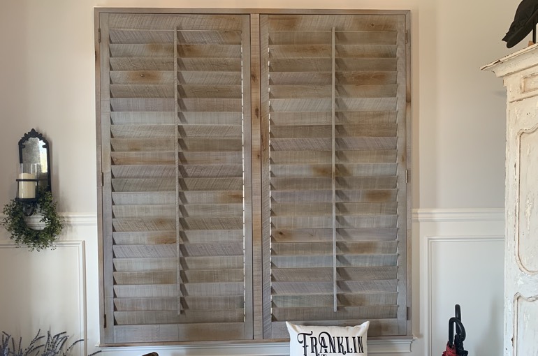 Reclaimed wood shutters over bench